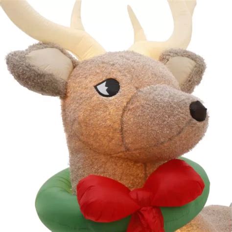 Home Accents Holiday 11 ft. Pre-Lit Airblown Inflatable Fuzzy Reindeer 1004370124 logo