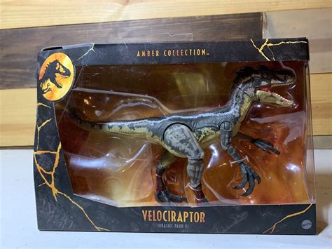 Mattel Jurassic World Amber Collection Velociraptor logo